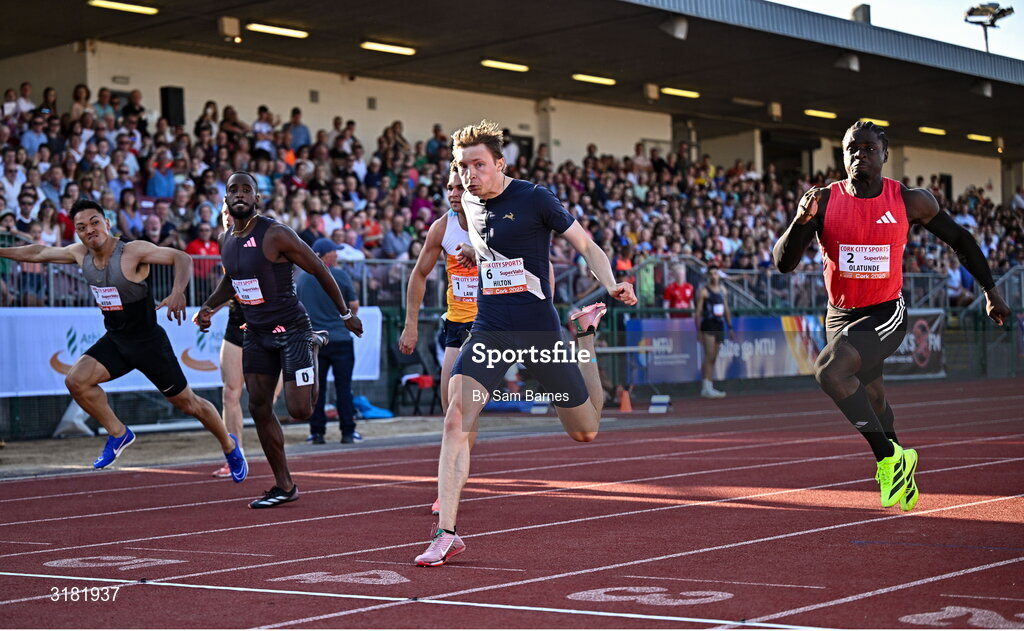 9 July 2025; Coby Hilton of USA, centre, finishes in first place ahead of Israel Olatunde of Ireland, right, who finished second, in the SuperValu Men's 100m Race 2 during the Cork City Sports meet at MTU Arena in Cork. Photo by Sam Barnes/Sportsfile