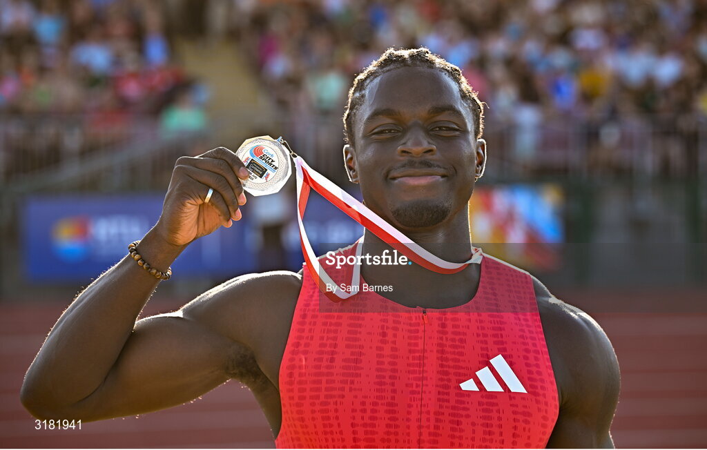 9 July 2025; Israel Olatunde of Ireland celebrates with his silver medal after finishing second in the SuperValu Men's 100m Race 2 during the Cork City Sports meet at MTU Arena in Cork. Photo by Sam Barnes/Sportsfile Photo by Sam Barnes/Sportsfile