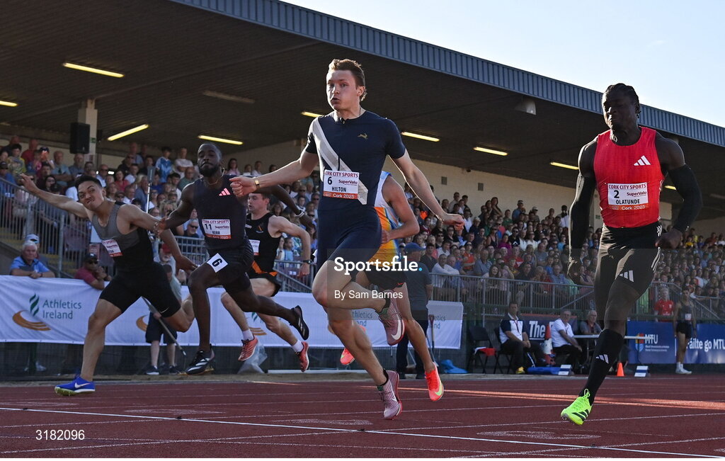 9 July 2025; Coby Hilton of USA, centre, finishes in first place ahead of Israel Olatunde of Ireland, right, who finished second, in the SuperValu Men's 100m Race 2 during the Cork City Sports meet at MTU Arena in Cork. Photo by Sam Barnes/Sportsfile