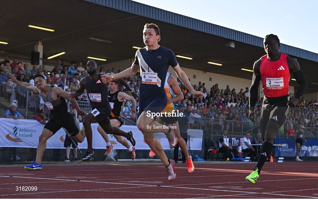 9 July 2025; Coby Hilton of USA, centre, finishes in first place ahead of Israel Olatunde of Ireland, right, who finished second, in the SuperValu Men's 100m Race 2 during the Cork City Sports meet at MTU Arena in Cork. Photo by Sam Barnes/Sportsfile