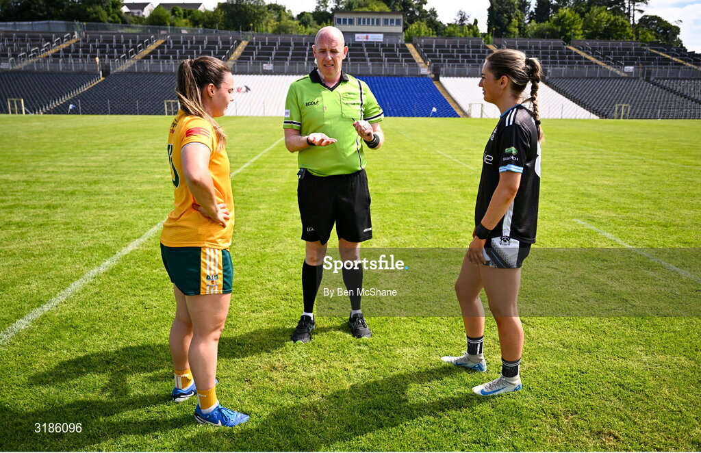 13 July 2025; Referee Paul McCaughey performs the coin-toss in the company of Antrim captain Bronagh Devlin, left, and Sligo captain Sinead Regan before the TG4 All-Ireland Ladies Football Junior Championship semi-final match between Antrim and Sligo at St Tiernach’s Park in Clones, Monaghan. Photo by Ben McShane/Sportsfile