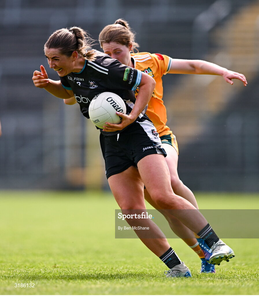 13 July 2025; Sinéad Regan of Sligo is tackled by Laura Agnew of Antrim during the TG4 All-Ireland Ladies Football Junior Championship semi-final match between Antrim and Sligo at St Tiernach’s Park in Clones, Monaghan. Photo by Ben McShane/Sportsfile