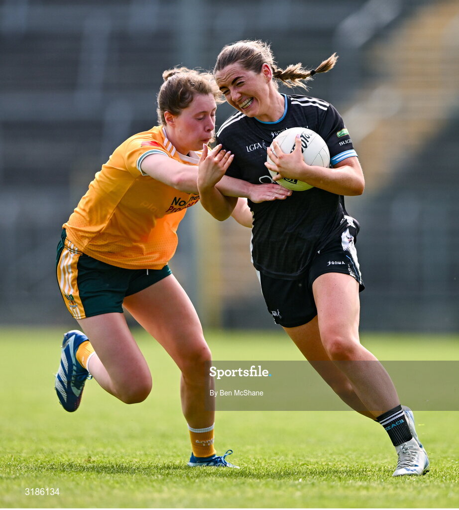 13 July 2025; Sinéad Regan of Sligo is tackled by Laura Agnew of Antrim during the TG4 All-Ireland Ladies Football Junior Championship semi-final match between Antrim and Sligo at St Tiernach’s Park in Clones, Monaghan. Photo by Ben McShane/Sportsfile