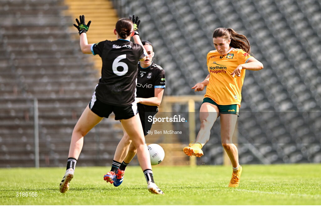 13 July 2025; Maria O'Neill of Antrim scores her side's first goal despite the attention of Robyn Kennedy, centre, and Ciara Walsh of Sligo during the TG4 All-Ireland Ladies Football Junior Championship semi-final match between Antrim and Sligo at St Tiernach’s Park in Clones, Monaghan. Photo by Ben McShane/Sportsfile