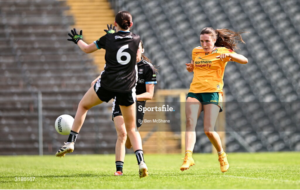 13 July 2025; Maria O'Neill of Antrim scores her side's first goal despite the attention of Robyn Kennedy, behind, and Ciara Walsh of Sligo during the TG4 All-Ireland Ladies Football Junior Championship semi-final match between Antrim and Sligo at St Tiernach’s Park in Clones, Monaghan. Photo by Ben McShane/Sportsfile