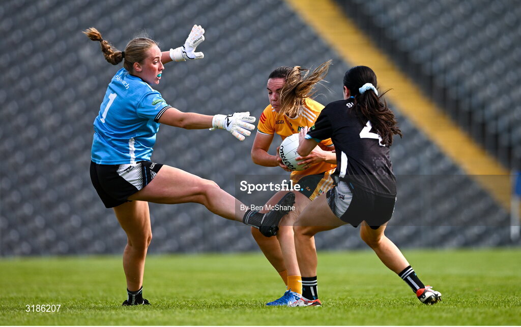 13 July 2025; Bronagh Devlin of Antrim is tackled by Hannah Walsh, right, and Sligo goalkeeper Ellen Maguire during the TG4 All-Ireland Ladies Football Junior Championship semi-final match between Antrim and Sligo at St Tiernach’s Park in Clones, Monaghan. Photo by Ben McShane/Sportsfile