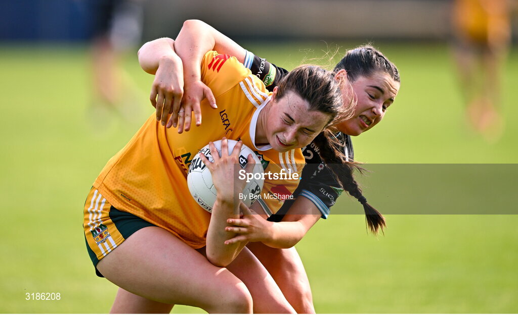 13 July 2025; Sarah O'Neill of Antrim is tackled by Sarah Feeney of Sligo during the TG4 All-Ireland Ladies Football Junior Championship semi-final match between Antrim and Sligo at St Tiernach’s Park in Clones, Monaghan. Photo by Ben McShane/Sportsfile