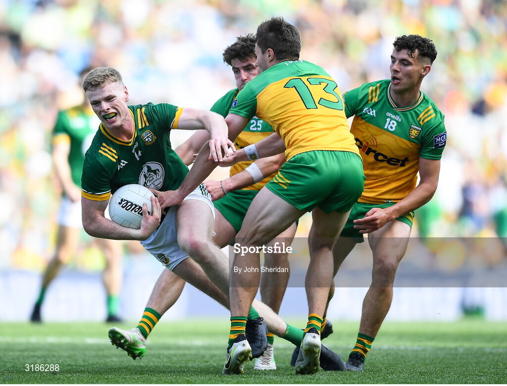 13 July 2025; Mathew Costello of Meath is tackled by Donegal players, from left, Dáire Ó Baoill, Conor O'Donnell and Odhran McFadden Ferry during the GAA Football All-Ireland Senior Championship semi-final match between Meath and Donegal at Croke Park in Dublin. Photo by John Sheridan/Sportsfile