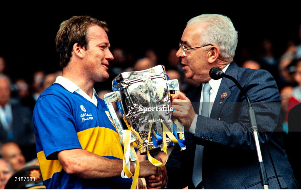 3 September 1989; Tipperary captain Bobby Ryan is presented with Liam MacCarthy cup by GAA President John Dowling after his side's victory during the All-Ireland Senior Hurling Championship Final match between Tipperary and Antrim at Croke Park in Dublin. Photo by Ray McManus/Sportsfile
