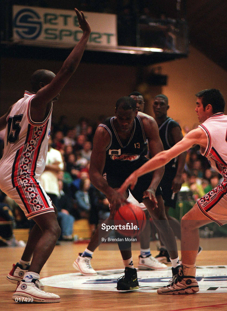 25 January 1998; Randall Mounts of Denny Notre Dame in action against Augusto Palacios, left, and Malcolm Thompson of Neptune during the Senior Men's Sprite National Cup Final between Denny Notre Dame and Neptune at the National Basketball Arena in Tallaght, Dublin. Photo By Brendan Moran/Sportsfile.