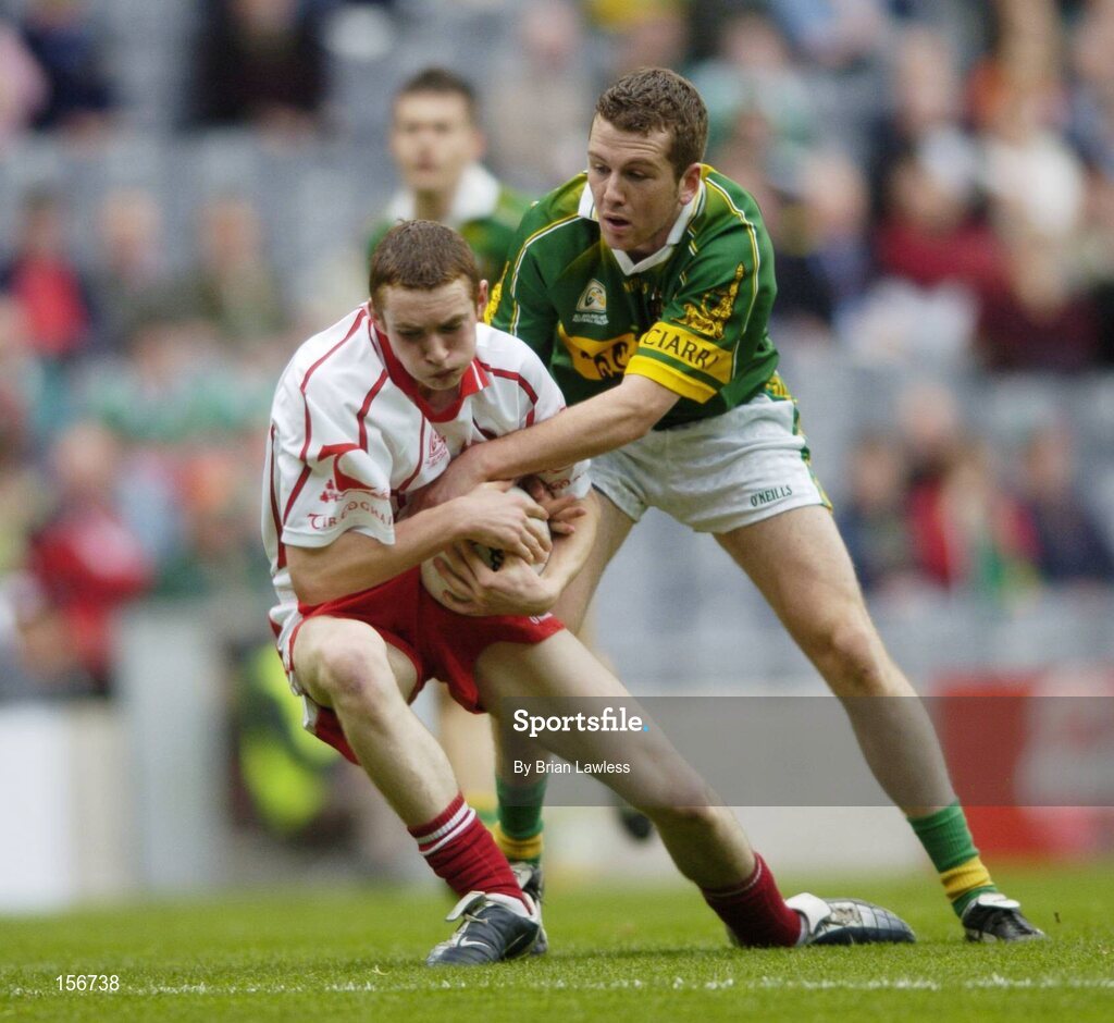 26 September 2004; Aiden Cassidy, Tyrone, in action against Luke Quinn, Kerry. All-Ireland Minor Football Championship Final, Kerry v Tyrone, Croke Park, Dublin. Picture credit; Brian Lawless / SPORTSFILE *** Local Caption *** Any photograph taken by SPORTSFILE during, or in connection with, the 2004 All-Ireland Minor Football Final which displays GAA logos or contains an image or part of an image of any GAA intellectual property, or, which contains images of a GAA player/players in their playing uniforms, may only be used for editorial and non-advertising purposes.  Use of photographs for advertising, as posters or for purchase separately is strictly prohibited unless prior written approval has been obtained from the Gaelic Athletic Association.