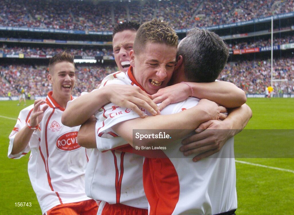 26 September 2004; Tyrone minor manager Liam Doyle, right, celebrates with players, from left, Niall Kerr, Shane O'Hagan and Gareth Devlin after victory in the final. All-Ireland Minor Football Championship Final, Kerry v Tyrone, Croke Park, Dublin. Picture credit; Brian Lawless / SPORTSFILE *** Local Caption *** Any photograph taken by SPORTSFILE during, or in connection with, the 2004 All-Ireland Minor Football Final which displays GAA logos or contains an image or part of an image of any GAA intellectual property, or, which contains images of a GAA player/players in their playing uniforms, may only be used for editorial and non-advertising purposes.  Use of photographs for advertising, as posters or for purchase separately is strictly prohibited unless prior written approval has been obtained from the Gaelic Athletic Association.