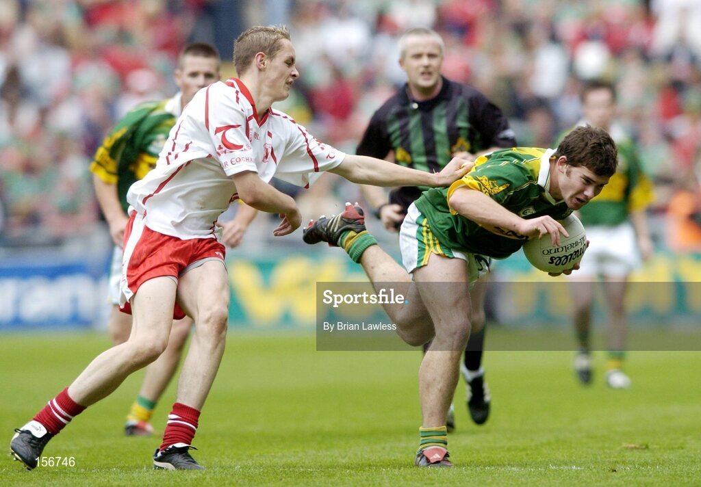 26 September 2004; Ciaran Kelliher, Kerry, in action against John Gilmore, Tyrone. All-Ireland Minor Football Championship Final, Kerry v Tyrone, Croke Park, Dublin. Picture credit; Brian Lawless / SPORTSFILE *** Local Caption *** Any photograph taken by SPORTSFILE during, or in connection with, the 2004 All-Ireland Minor Football Final which displays GAA logos or contains an image or part of an image of any GAA intellectual property, or, which contains images of a GAA player/players in their playing uniforms, may only be used for editorial and non-advertising purposes.  Use of photographs for advertising, as posters or for purchase separately is strictly prohibited unless prior written approval has been obtained from the Gaelic Athletic Association.