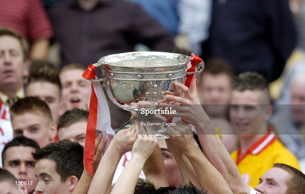 26 September 2004; Tyrone players lift the Tom Markham Cup. All-Ireland Minor Football Championship Final, Kerry v Tyrone, Croke Park, Dublin. Picture credit; Damien Eagers / SPORTSFILE *** Local Caption *** Any photograph taken by SPORTSFILE during, or in connection with, the 2004 All-Ireland Minor  Football Final which displays GAA logos or contains an image or part of an image of any GAA intellectual property, or, which contains images of a GAA player/players in their playing uniforms, may only be used for editorial and non-advertising purposes.  Use of photographs for advertising, as posters or for purchase separately is strictly prohibited unless prior written approval has been obtained from the Gaelic Athletic Association.