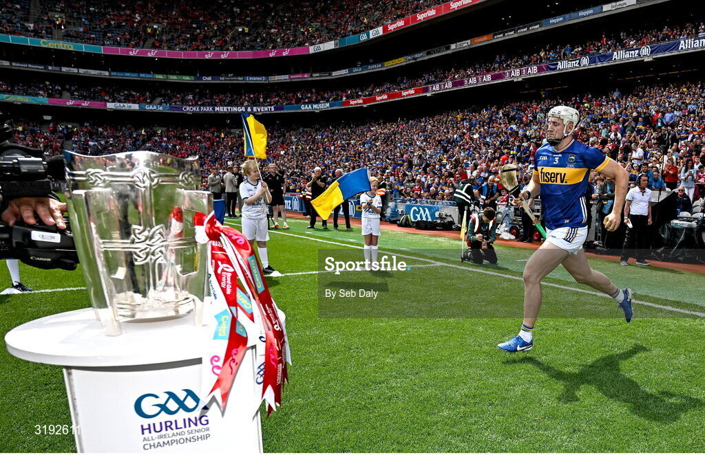20 July 2025; Eoghan Connolly of Tipperary runs onto the pitch past the Liam MacCarthy cup before the GAA Hurling All-Ireland Senior Championship final match between Cork and Tipperary at Croke Park in Dublin. Photo by Seb Daly/Sportsfile