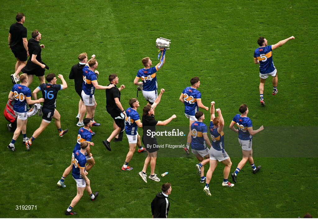 20 July 2025; Tipperary players including John McGrath, 14, run toward Hill 16 with the Liam MacCarthy Cup after their side's victory in the GAA Hurling All-Ireland Senior Championship final match between Cork and Tipperary at Croke Park in Dublin. Photo by David Fitzgerald/Sportsfile