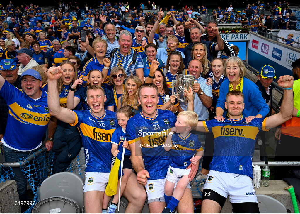 20 July 2025; Tipperary players and brothers, from left, Brian McGrath, Noel McGrath and John McGrath celebrate with family and the Liam MacCarthy Cup after their side's victory in the GAA Hurling All-Ireland Senior Championship final match between Cork and Tipperary at Croke Park in Dublin. Photo by Stephen McCarthy/Sportsfile