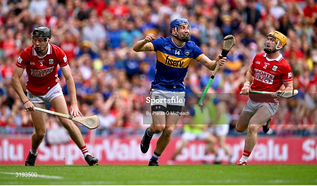 20 July 2025; John McGrath of Tipperary celebrates scoring his side's first goal as Cork players Eoin Downey and Niall O'Leary, right, after the GAA Hurling All-Ireland Senior Championship final match between Cork and Tipperary at Croke Park in Dublin. Photo by Piaras Ó Mídheach/Sportsfile