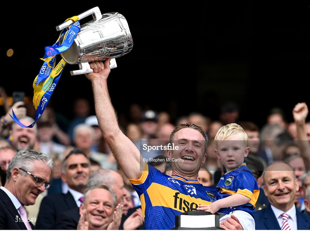20 July 2025; Noel McGrath of Tipperary and his son Sam lift the Liam MacCarthy cup after victory in the GAA Hurling All-Ireland Senior Championship final match between Cork and Tipperary at Croke Park in Dublin. Photo by Stephen McCarthy/Sportsfile