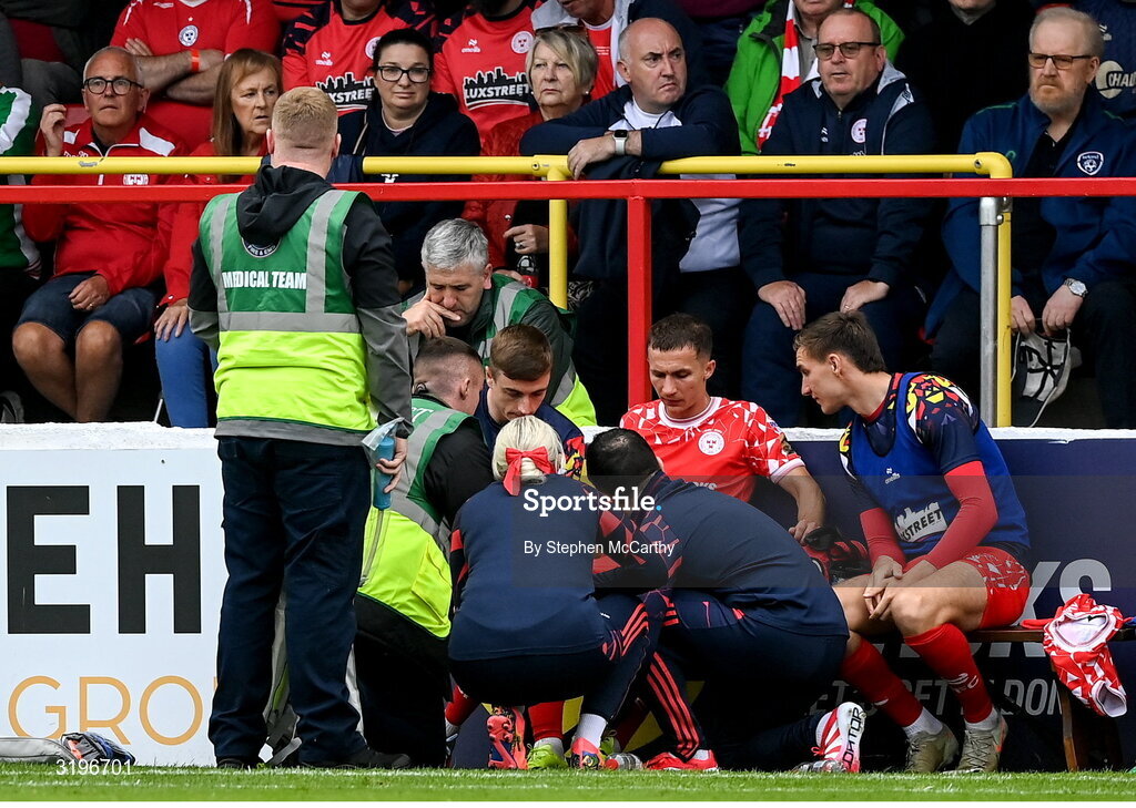 23 July 2025; Tyreke Wilson of Shelbourne receives medical attention after picking up an injury during the UEFA Champions League Second Qualifying Round first leg match between Shelbourne and Qarabag FK at Tolka Park in Dublin. Photo by Stephen McCarthy/Sportsfile