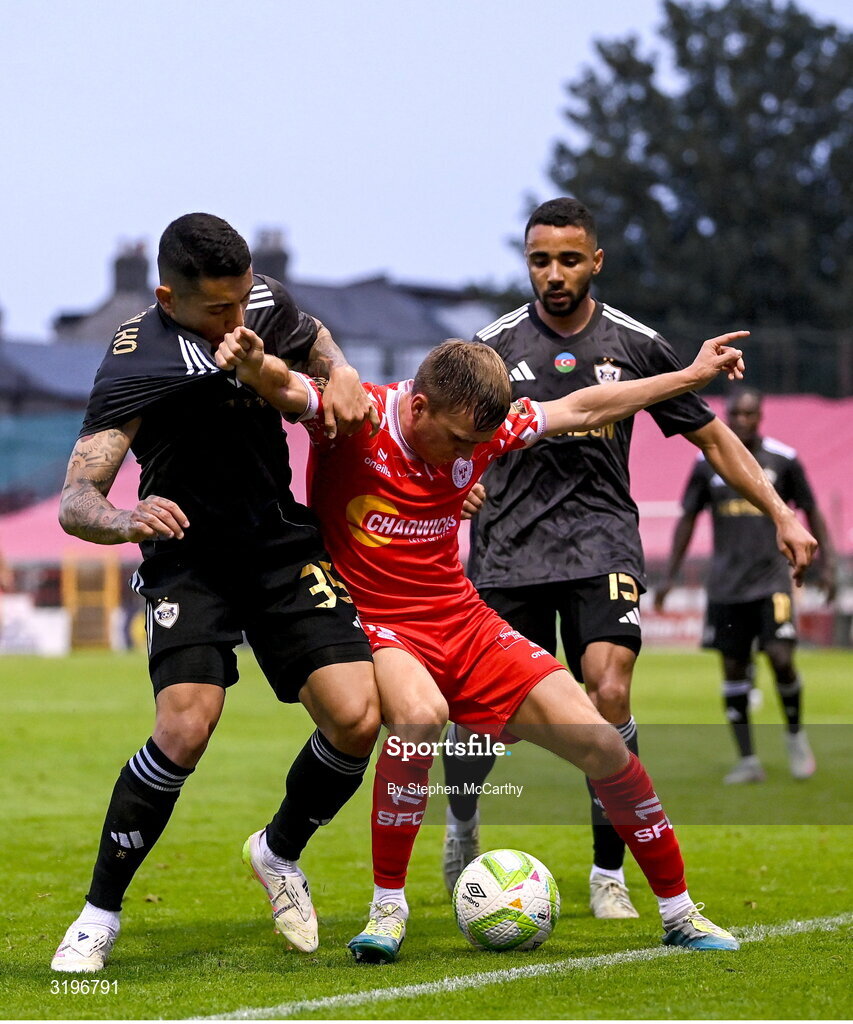 23 July 2025; James Norris of Shelbourne in action against Pedro Bicalho, left, and Leandro Andrade of Qarabag during the UEFA Champions League Second Qualifying Round first leg match between Shelbourne and Qarabag FK at Tolka Park in Dublin. Photo by Stephen McCarthy/Sportsfile