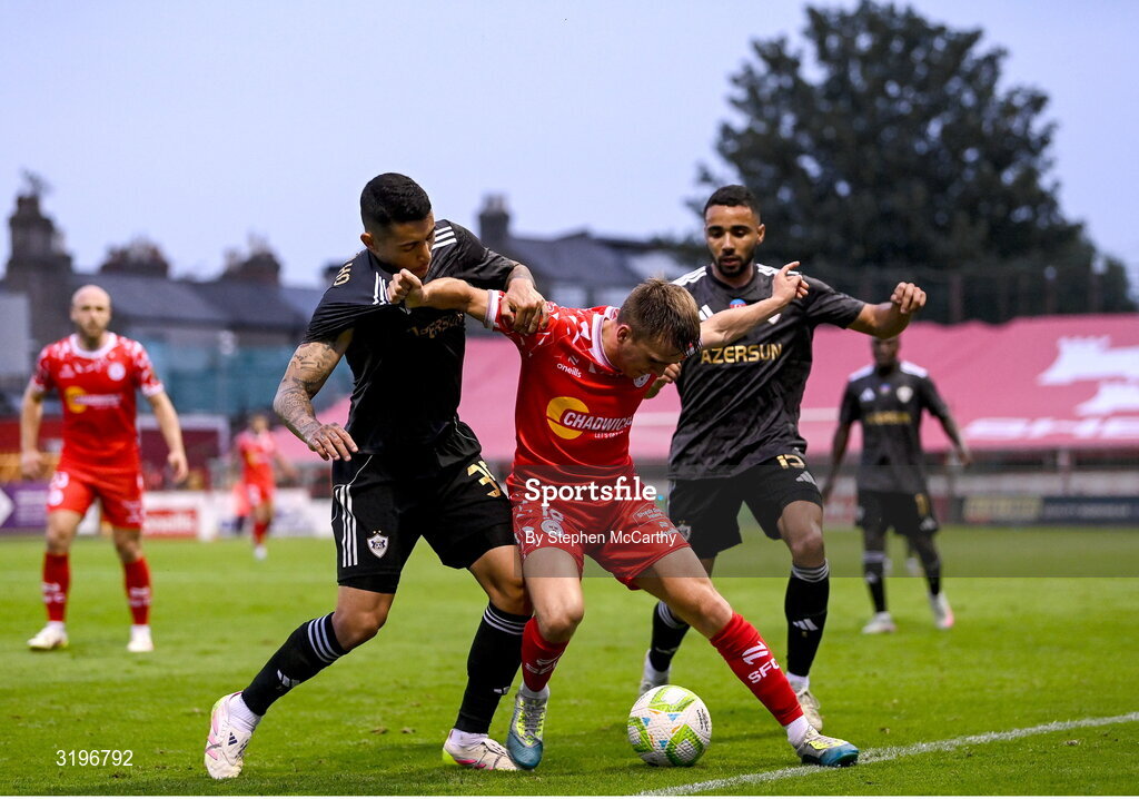 23 July 2025; James Norris of Shelbourne in action against Pedro Bicalho, left, and Leandro Andrade of Qarabag during the UEFA Champions League Second Qualifying Round first leg match between Shelbourne and Qarabag FK at Tolka Park in Dublin. Photo by Stephen McCarthy/Sportsfile