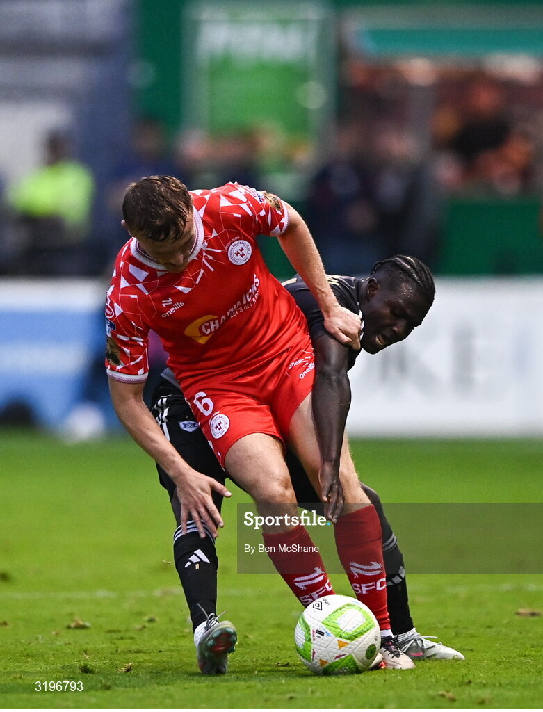 23 July 2025; JJ Lunney of Shelbourne is tackled by Emmanuel Addai of Qarabag during the UEFA Champions League Second Qualifying Round first leg match between Shelbourne and Qarabag FK at Tolka Park in Dublin. Photo by Ben McShane/Sportsfile