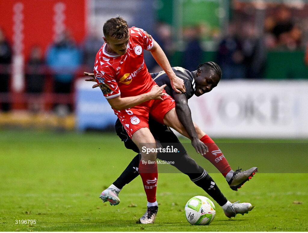 23 July 2025; JJ Lunney of Shelbourne is tackled by Emmanuel Addai of Qarabag during the UEFA Champions League Second Qualifying Round first leg match between Shelbourne and Qarabag FK at Tolka Park in Dublin. Photo by Ben McShane/Sportsfile