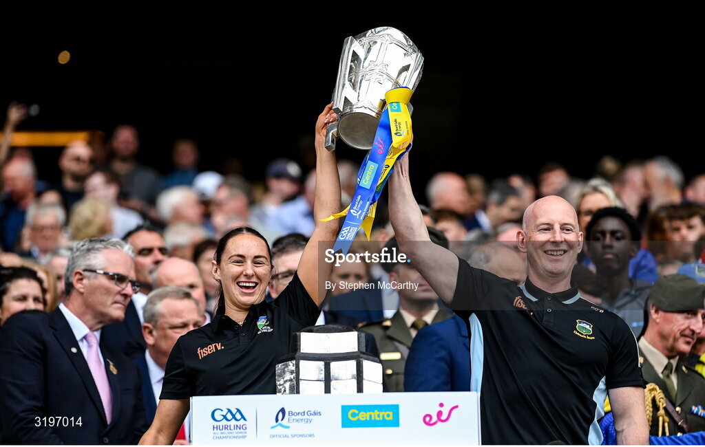 20 July 2025; Tipperary Physical Therapist Sarah Cuddy and Team Physiotherapist Paddy O'Brien lift the Liam MacCarthy Cup after the GAA Hurling All-Ireland Senior Championship final match between Cork and Tipperary at Croke Park in Dublin. Photo by Stephen McCarthy/Sportsfile