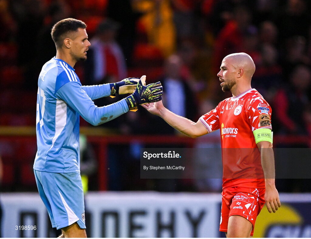 23 July 2025; Mark Coyle of Shelbourne and Qarabag goalkeeper Fabijan Buntic during the UEFA Champions League Second Qualifying Round first leg match between Shelbourne and Qarabag FK at Tolka Park in Dublin. Photo by Stephen McCarthy/Sportsfile