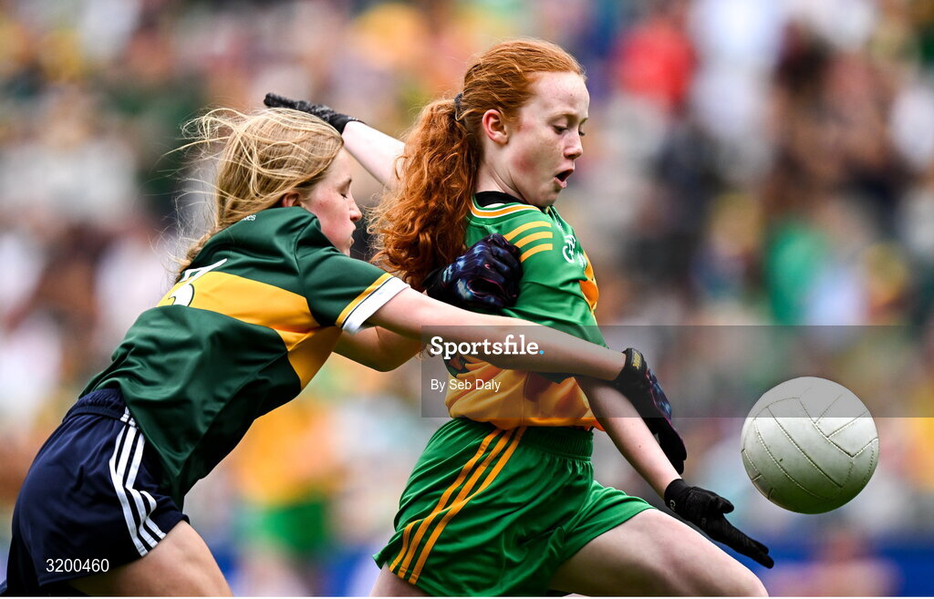 27 July 2025; Úna Kilkenny, St Mary's PS, Mullaghbawn, Armagh, representing Donegal, in action against Ellie Dooley, Herbertstown NS, Herbertstown, Limerick, representing Kerry, during the GAA INTO Cumann na mBunscol Respect Exhibition Go Games at the GAA Football All-Ireland Senior Championship final match between Kerry and Donegal at Croke Park in Dublin. Photo by Seb Daly/Sportsfile