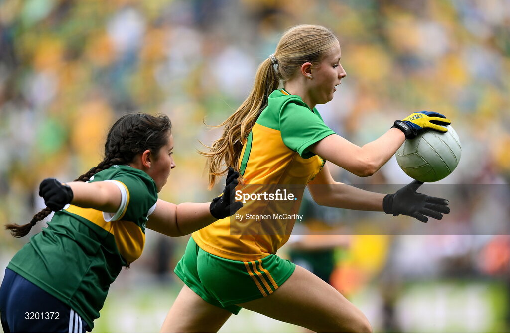 27 July 2025; Rebecca Farrell, St Patrick's NS, Castleknock, Dublin, representing Donegal, and Zoe Dunne, Scoil Mhuire, Allenwood, Kildare, representing Kerry, during the GAA INTO Cumann na mBunscol Respect Exhibition Go Games at the GAA Football All-Ireland Senior Championship final match between Kerry and Donegal at Croke Park in Dublin. Photo by Stephen McCarthy/Sportsfile