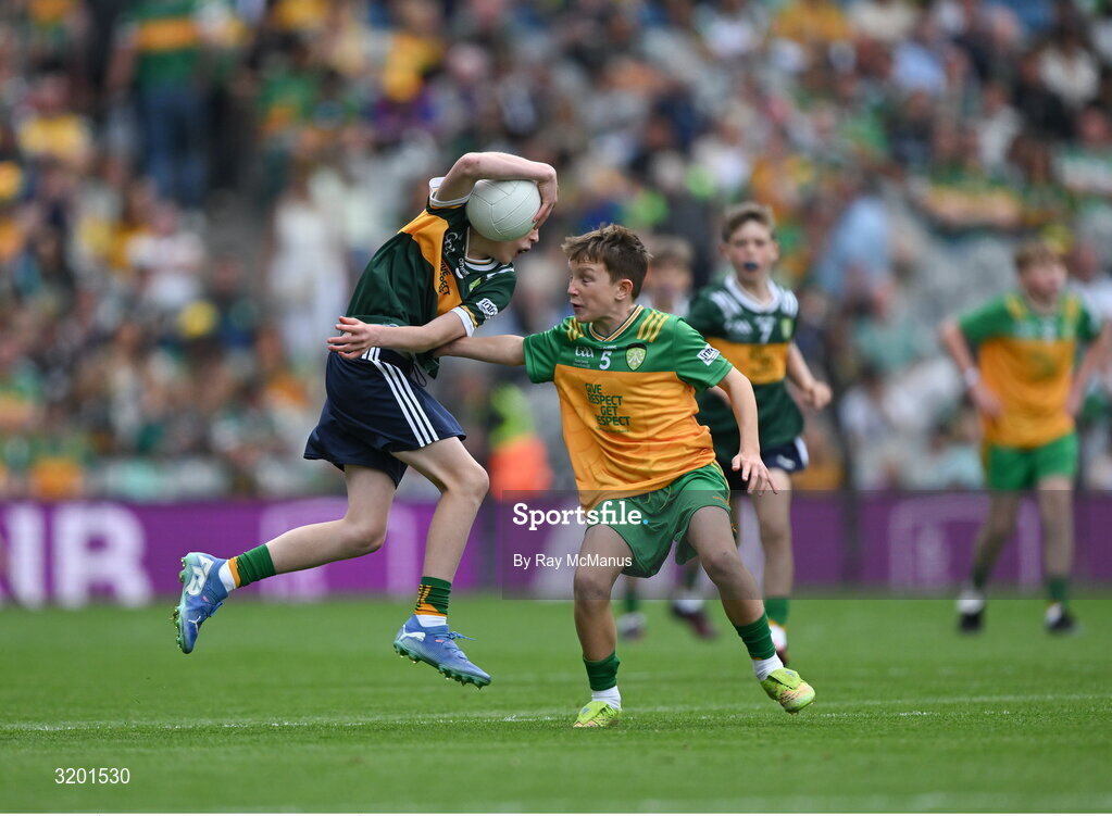 27 July 2025; Keelan Sweeney, St Andrews National School Curragha, representing Meath, is tackled by Marc Ó Gairbhí, Gaelscoil Ultain, Baile Mhuineacháin, Co. Mhuineacháin, representing Donegal, during the GAA INTO Cumann na mBunscol Respect Exhibition Go Games at the GAA Football All-Ireland Senior Championship final match between Kerry and Donegal at Croke Park in Dublin. Photo by Ray McManus/Sportsfile