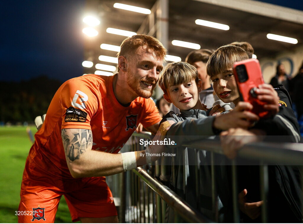 1 August 2025; Dundalk goalkeeper Enda Minogue has his photo taken with supporters after the SSE Airtricity Men's First Division match between UCD and Dundalk at UCD Bowl in Belfield, Dublin. Photo by Thomas Flinkow/Sportsfile