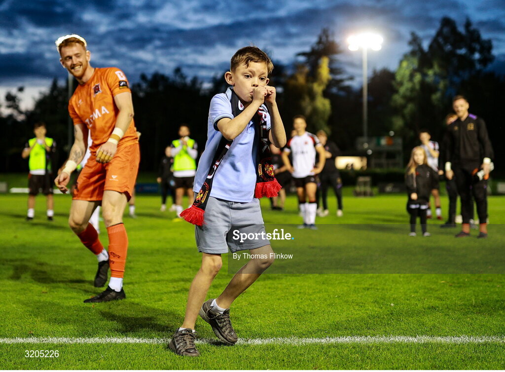 1 August 2025; Young Dundalk supporter Charlie O'Hegan celebrates with goalkeeper Enda Minogue after the SSE Airtricity Men's First Division match between UCD and Dundalk at UCD Bowl in Belfield, Dublin. Photo by Thomas Flinkow/Sportsfile