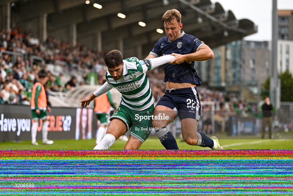 3 August 2025; Danny Mandroiu of Shamrock Rovers in action against Jamie Stott of Derry City during the SSE Airtricity Men's Premier Division match between Shamrock Rovers and Derry City at Tallaght Stadium in Dublin.  Photo by Ben McShane/Sportsfile