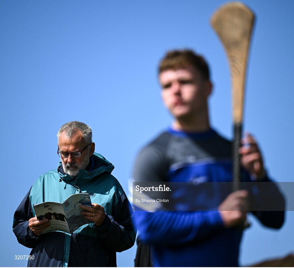 4 August 2025; Iar Uachtarán Chumann Lúthchleas Gael Larry McCarthy, left, inspects an event programme as Sean Og O'Regan of Waterford competes in the Hurling Under 16 competition during the M. Donnelly GAA Poc Fada All-Ireland Finals at Annaverna Mountain in the Cooley Peninsula, Ravensdale, Louth. Photo by Shauna Clinton/Sportsfile