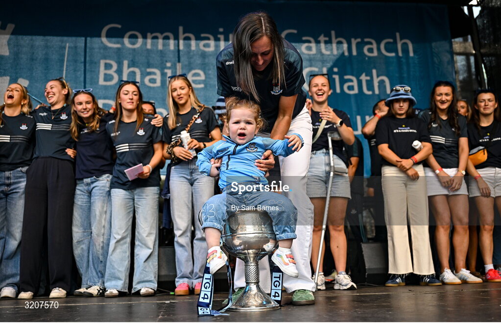 5 August 2025; Hannah Tyrrell, with her daughter Aoife, age 2, in The Brendan Martin Cup during the homecoming of TG4 All-Ireland Ladies Senior Football Champions, Dublin, at Smithfield Square in Dublin. Photo by Sam Barnes/Sportsfile