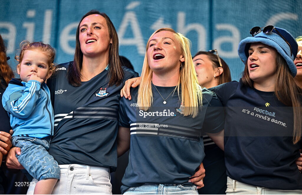 5 August 2025; Dublin players, from left, Hannah Tyrrell, holding her daughter Aoife, Carla Rowe and Kate Sullivan during the homecoming of TG4 All-Ireland Ladies Senior Football Champions, Dublin, at Smithfield Square in Dublin. Photo by Sam Barnes/Sportsfile