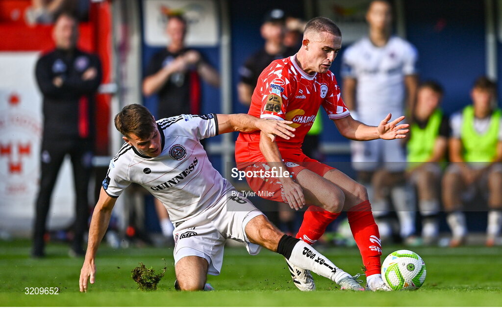 9 August 2025; Evan Caffrey of Shelbourne is tackled by Dayle Rooney of Bohemians during the SSE Airtricity Men's Premier Division match between Shelbourne and Bohemians at Tolka Park in Dublin. Photo by Tyler Miller/Sportsfile