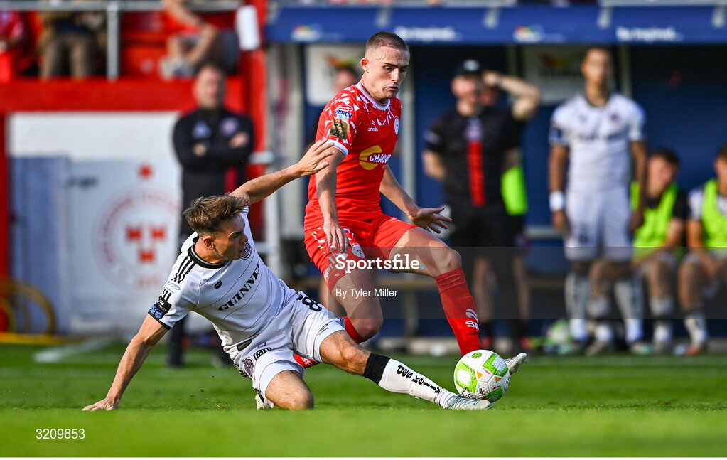 9 August 2025; Evan Caffrey of Shelbourne is tackled by Dayle Rooney of Bohemians during the SSE Airtricity Men's Premier Division match between Shelbourne and Bohemians at Tolka Park in Dublin. Photo by Tyler Miller/Sportsfile