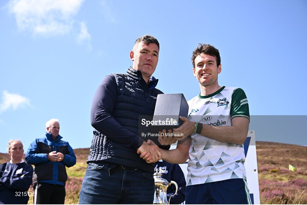 4 August 2025; GAA National Head of Hurling Willie Maher, left, makes a presentation to Darren Geoghegan of Louth after the M. Donnelly GAA Poc Fada All-Ireland Finals at Annaverna Mountain in the Cooley Peninsula, Ravensdale, Louth. Photo by Piaras Ó Mídheach/Sportsfile