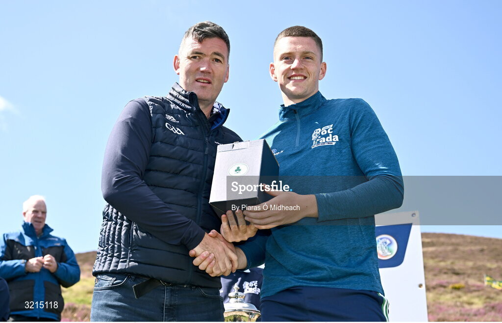 4 August 2025; GAA National Head of Hurling Willie Maher, left, makes a presentation to Sean Óg McLaren of Antrim after the M. Donnelly GAA Poc Fada All-Ireland Finals at Annaverna Mountain in the Cooley Peninsula, Ravensdale, Louth. Photo by Piaras Ó Mídheach/Sportsfile