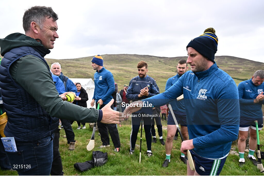 4 August 2025; GAA National Head of Hurling Willie Maher presents a sliotar to Cathal Dillon of Tipperary before the M. Donnelly GAA Poc Fada All-Ireland Finals at Annaverna Mountain in the Cooley Peninsula, Ravensdale, Louth. Photo by Piaras Ó Mídheach/Sportsfile