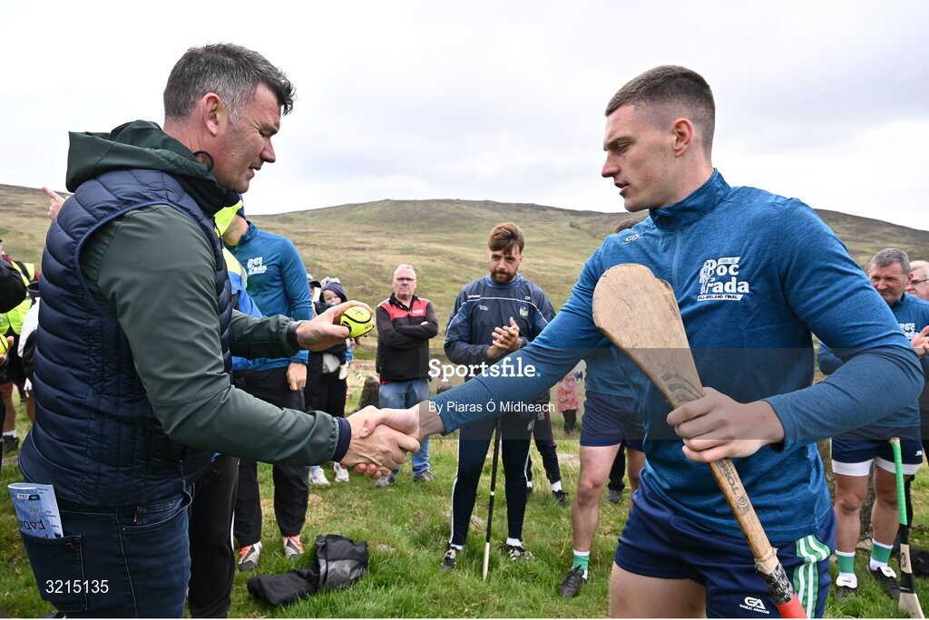 4 August 2025; GAA National Head of Hurling Willie Maher presents a sliotar to Seán Óg McLaren of Antrim before the M. Donnelly GAA Poc Fada All-Ireland Finals at Annaverna Mountain in the Cooley Peninsula, Ravensdale, Louth. Photo by Piaras Ó Mídheach/Sportsfile