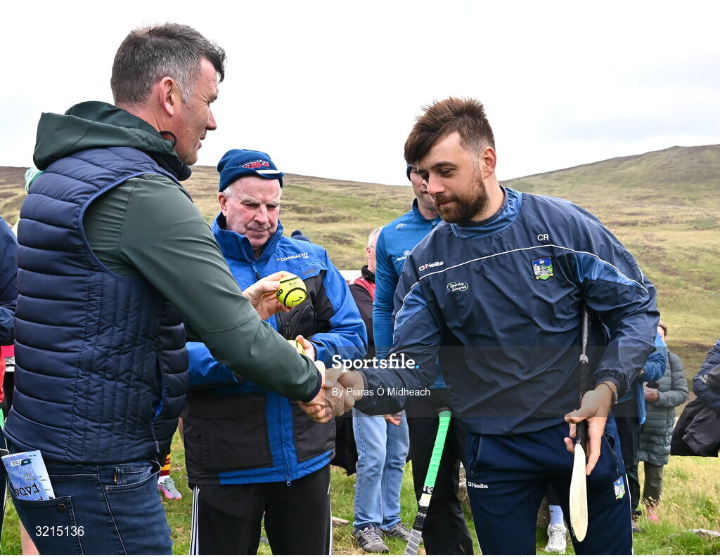 4 August 2025; GAA National Head of Hurling Willie Maher presents a sliotar to Colin Ryan of Limerick before the M. Donnelly GAA Poc Fada All-Ireland Finals at Annaverna Mountain in the Cooley Peninsula, Ravensdale, Louth. Photo by Piaras Ó Mídheach/Sportsfile