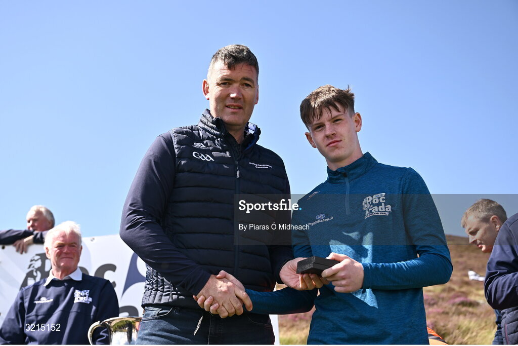 4 August 2025; GAA National Head of Hurling Willie Maher, left, makes a presentation to Donnacha Collins of Derry after the M. Donnelly GAA Poc Fada All-Ireland Finals at Annaverna Mountain in the Cooley Peninsula, Ravensdale, Louth. Photo by Piaras Ó Mídheach/Sportsfile