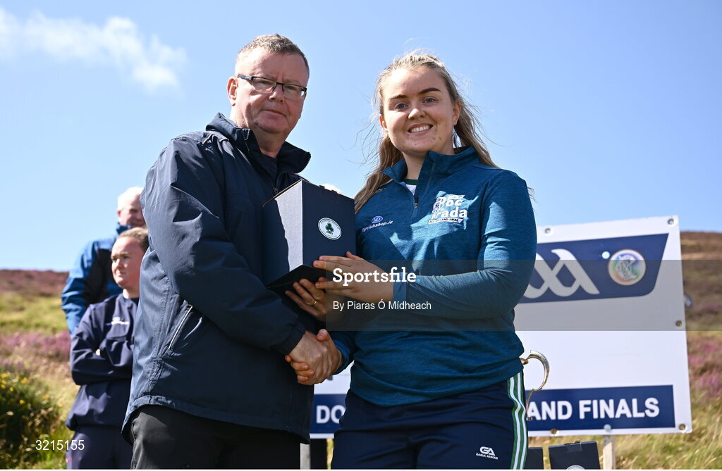 4 August 2025; Camogie President Brian Molloy makes a presentation to Patricia Coote of Westmeath after the M. Donnelly GAA Poc Fada All-Ireland Finals at Annaverna Mountain in the Cooley Peninsula, Ravensdale, Louth. Photo by Piaras Ó Mídheach/Sportsfile