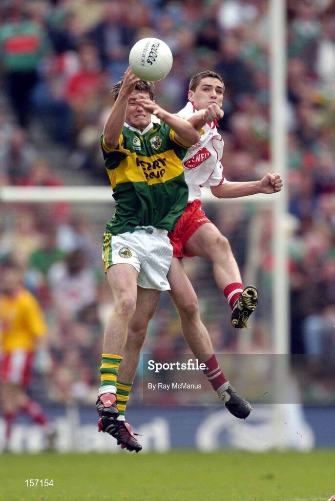 26 September 2004; David Culloty of Kerry in action against John Kelly of Tyrone during the All-Ireland Minor Football Championship Final match between Kerry and Tyrone at Croke Park in Dublin. Photo by Ray McManus/Sportsfile *** Local Caption *** Any photograph taken by SPORTSFILE during, or in connection with, the 2004 All-Ireland Minor Football Final which displays GAA logos or contains an image or part of an image of any GAA intellectual property, or, which contains images of a GAA player/players in their playing uniforms, may only be used for editorial and non-advertising purposes.  Use of photographs for advertising, as posters or for purchase separately is strictly prohibited unless prior written approval has been obtained from the Gaelic Athletic Association.