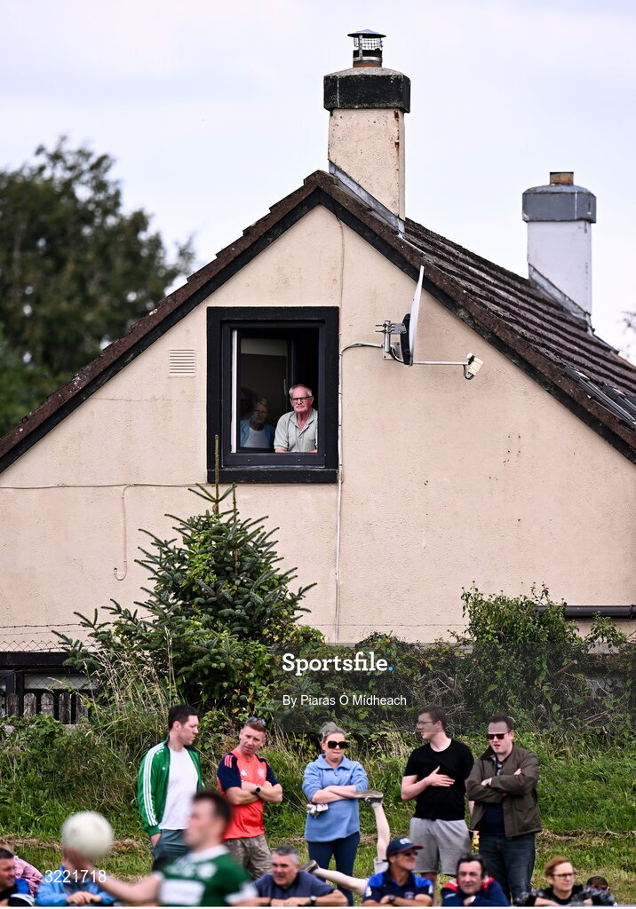 24 August 2025; A man looks on from a nearby house as Paul Towey of Charlestown Sarsfields prepares to take a free during the Mayo County Senior Club Football Championship Round 2 match between Charlestown Sarsfields and Ballaghaderreen at Fr O'Hara Park in Charlestown, Mayo. Photo by Piaras Ó Mídheach/Sportsfile